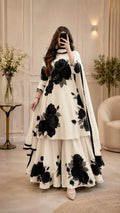 Model wearing an ivory flared set with large black flowers – digital printed silk 3-piece suit