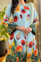 Model wearing a sky blue suit with a tulip print – digital printed silk 3-piece suit