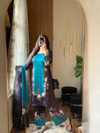 Model wearing a teal kurta with dark floral print trousers and dupatta – digital printed silk 3-piece suit